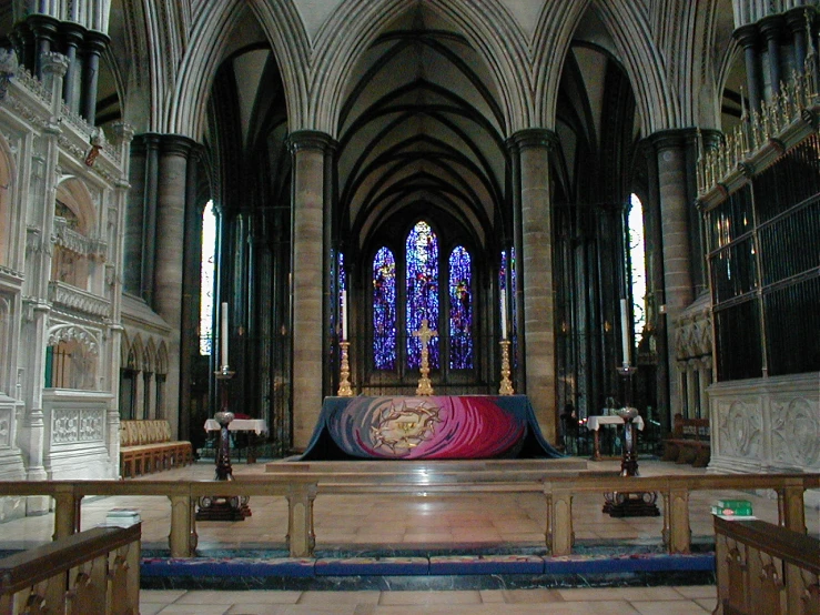 the alter of a medieval church with a huge cloth dd on it