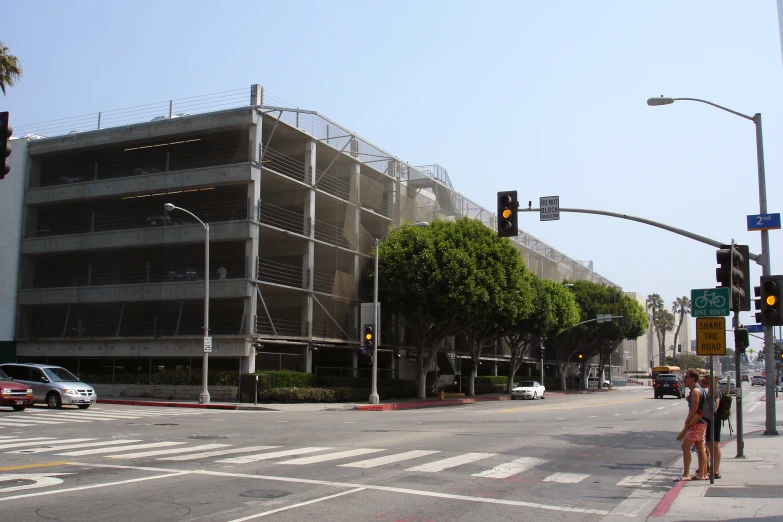 an empty street is shown with a traffic light and buildings