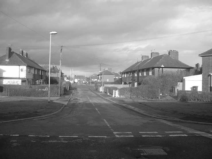 an empty street leading up to several homes