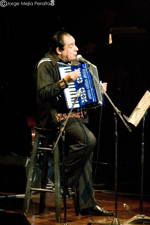 a man holding an oriental musical instrument in his hands