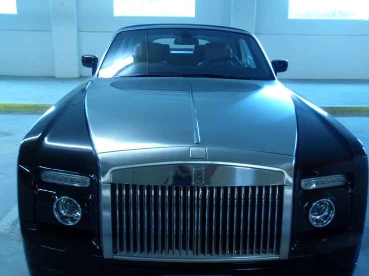 a fancyly designed rolls royce parked inside