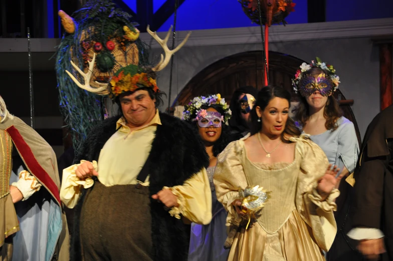 a group of people in costume on stage