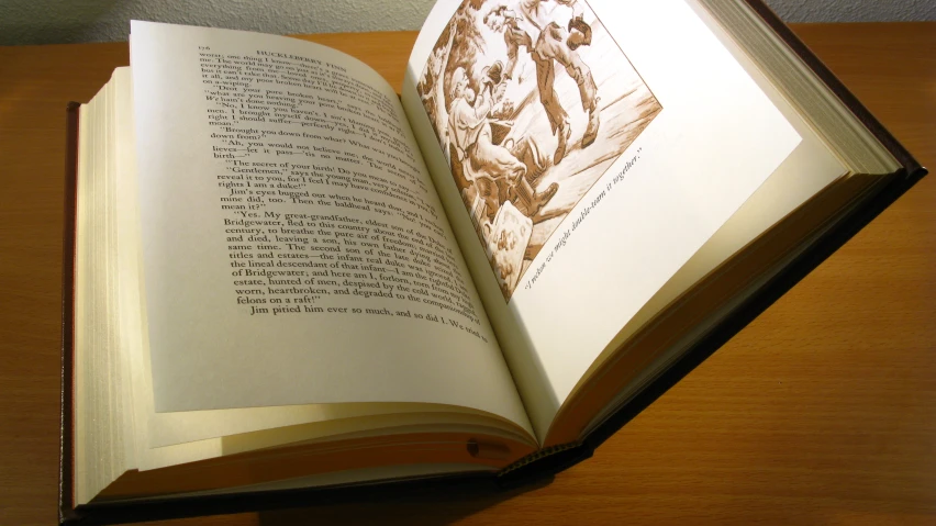 open book laying on top of a wooden table