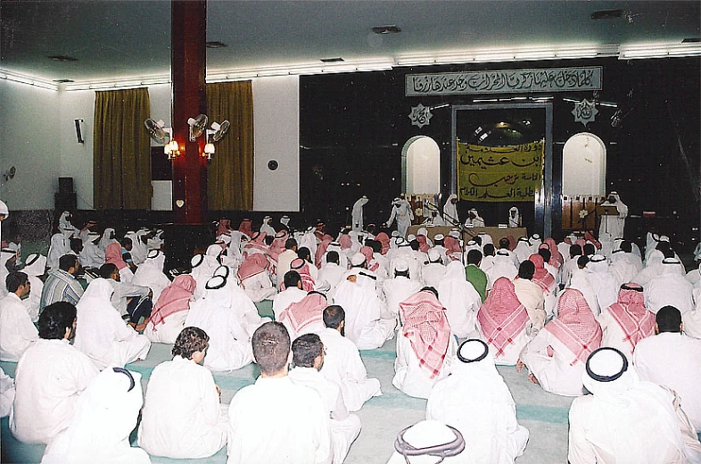 a crowd of people are dressed up sitting down