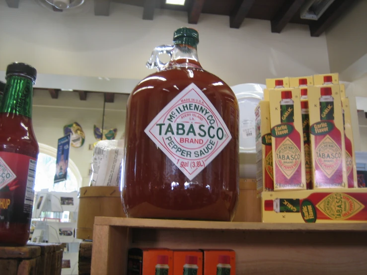 a group of bottles of bbq are sitting next to a shelf