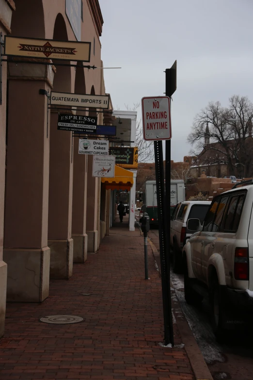 a street sign for parking meter at a city block