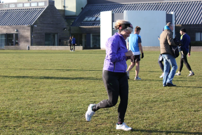 a group of people playing frisbee in the park