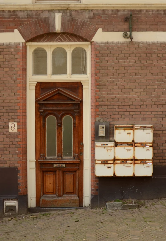 a big wooden door with some boxes sitting by it