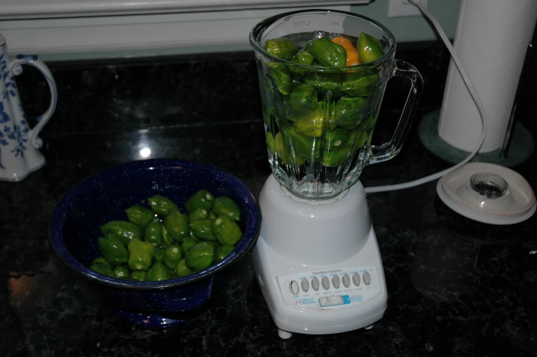 a blender is filled with peppers on a counter top