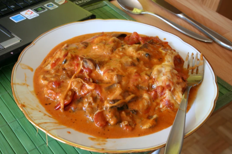 a plate of ravioli topped with cheese and tomatoes