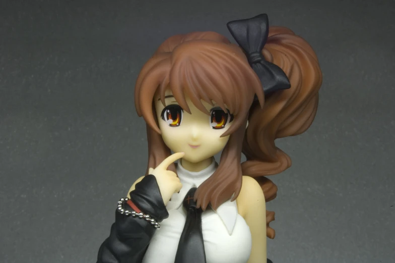 a girl figurine in black and white is holding her finger up to the side