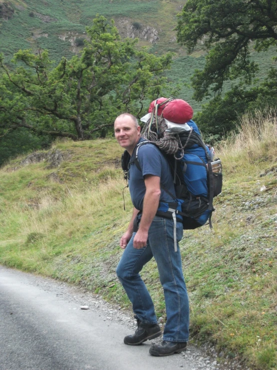 there is a man with a backpack on the side of the road