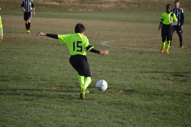 a man is kicking a soccer ball during a game