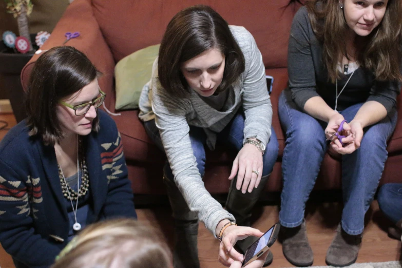 a group of women that are sitting on a couch