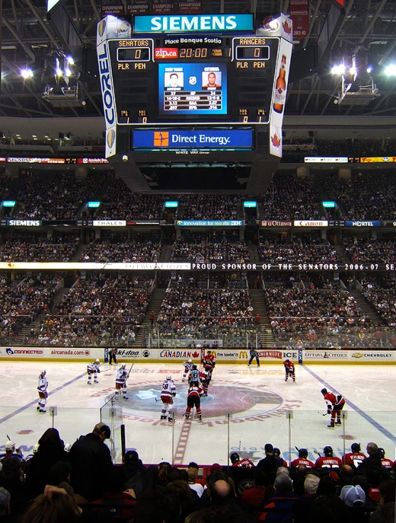 hockey on the ice with fans in the stands