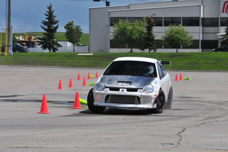 an automobile on a race track in front of many cones