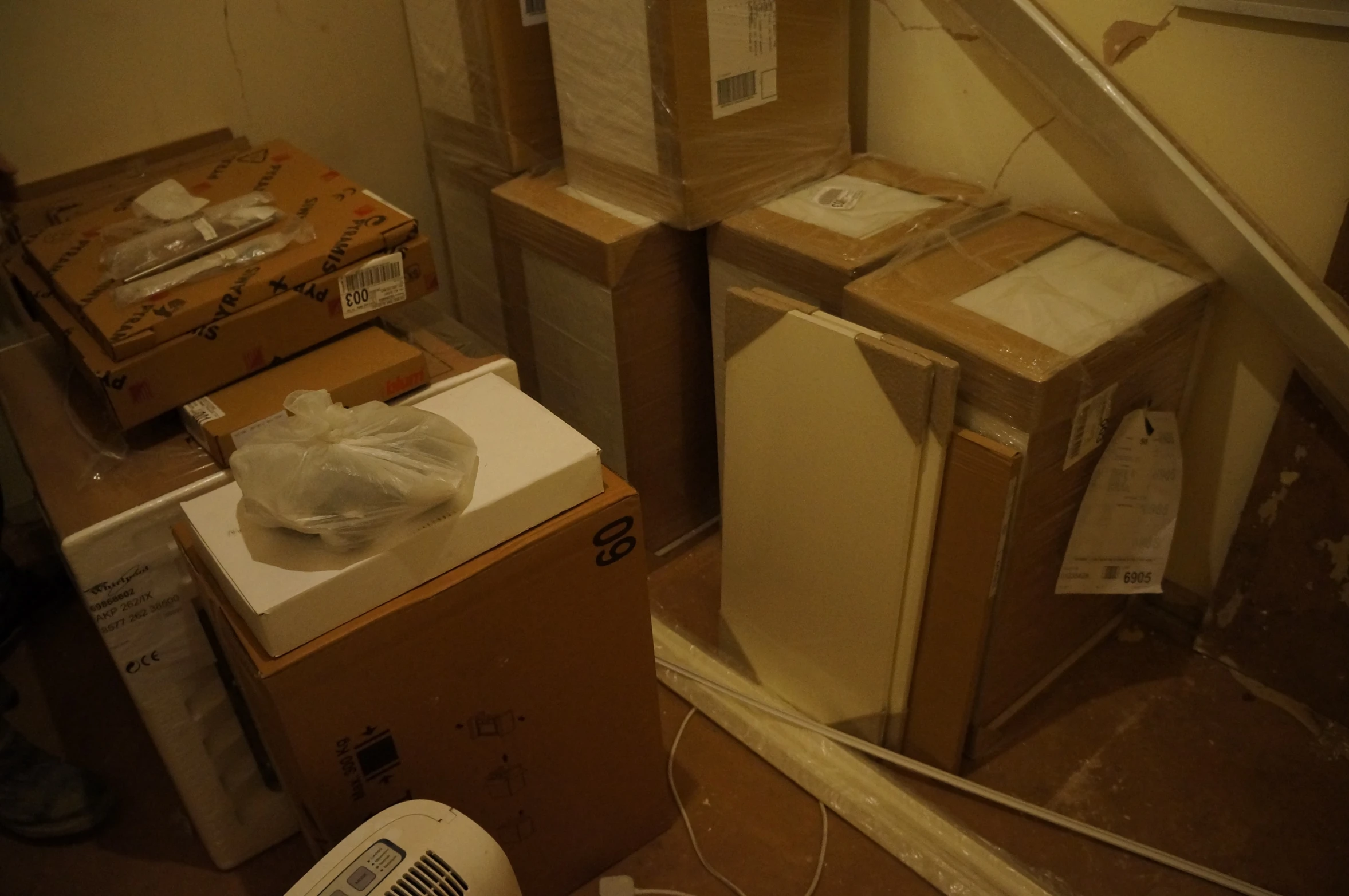 some brown boxes and a staircase and two fan