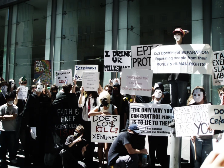 a group of protesters is holding up their protest signs