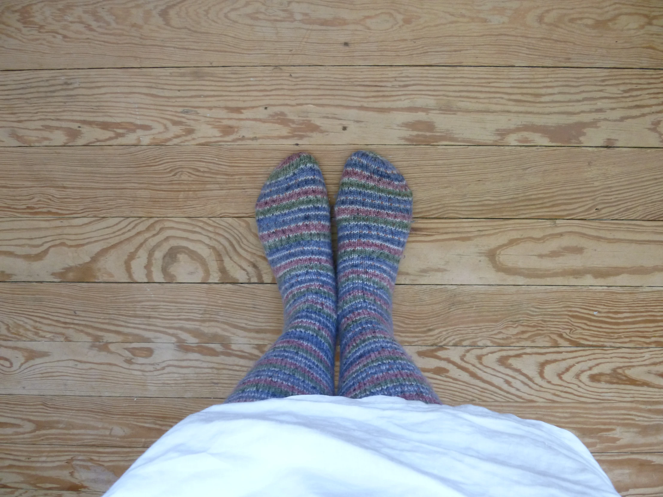 a woman's legs with blue socks and purple shoes