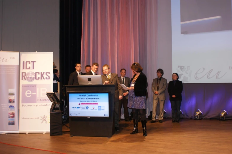 a group of people on stage at a meeting