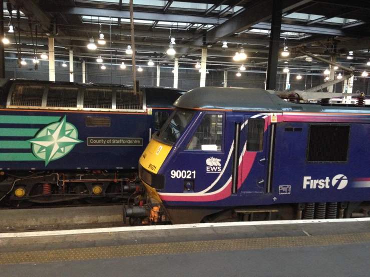 a passenger train stopped at the platform in a station