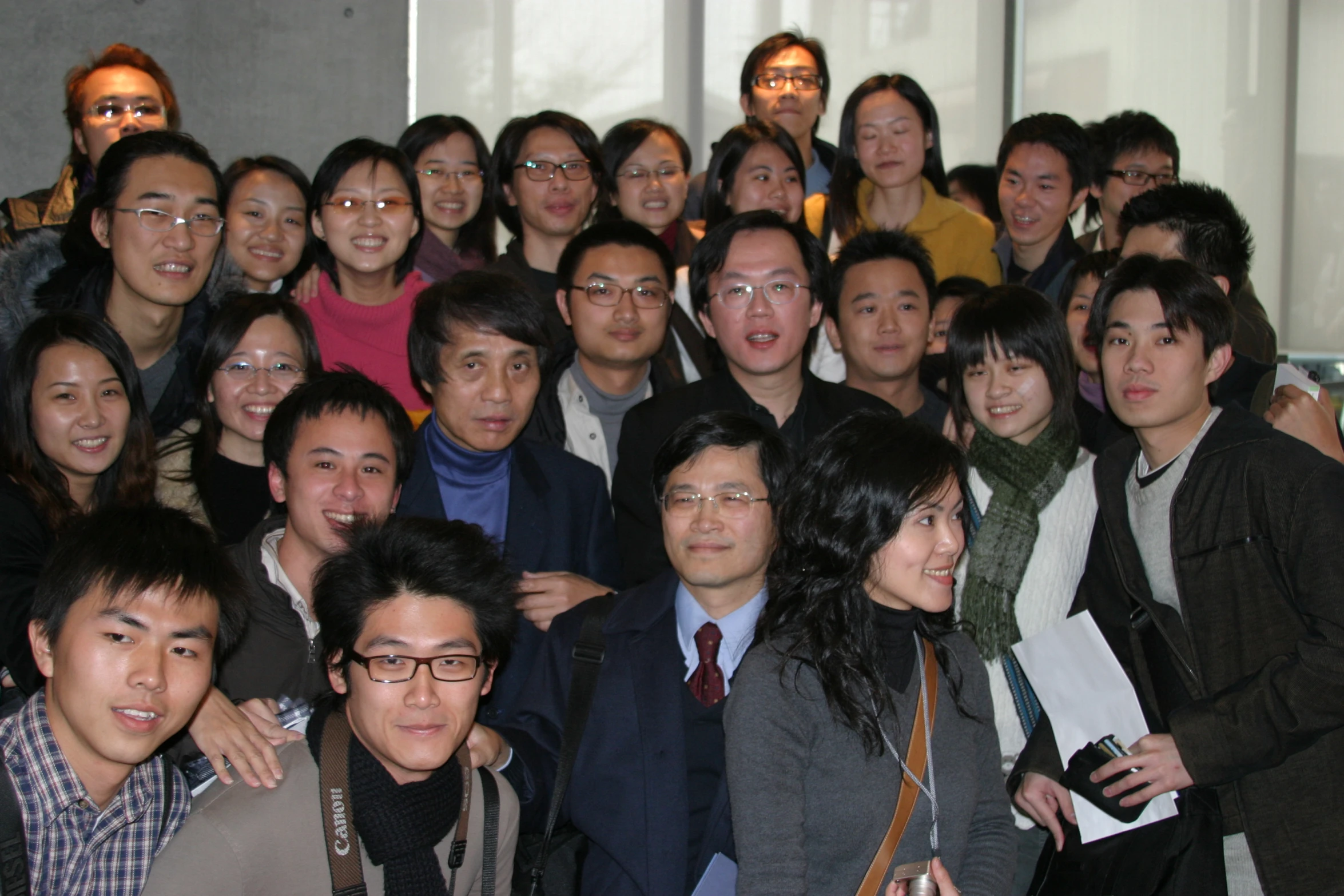 a group of asian people posing together for a po