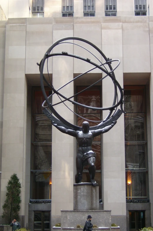 a statue of a man and a large circle with people in it