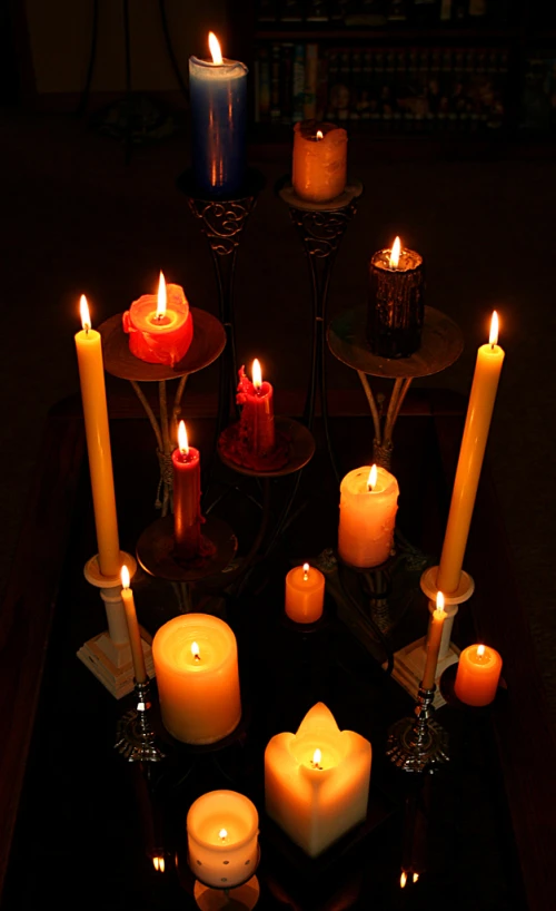 seven candles lit sitting on an illuminated tray