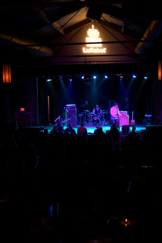 a concert scene with a band on stage