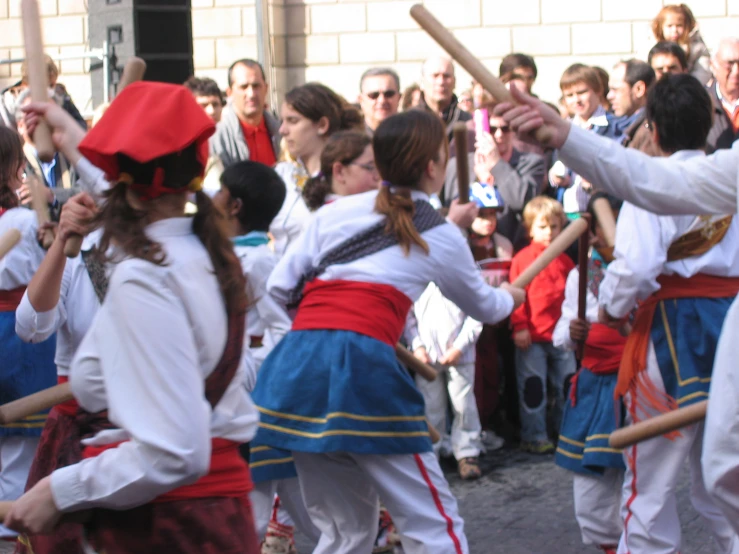 several women in traditional costumes are playing a game