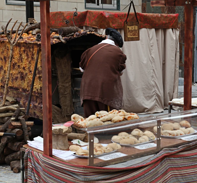 man selling bread at an outdoor marketplace