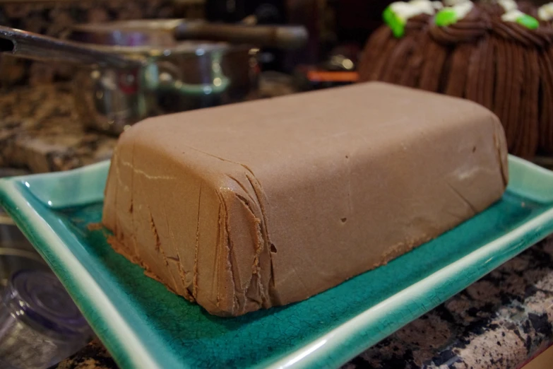 a piece of brown cake on a green tray