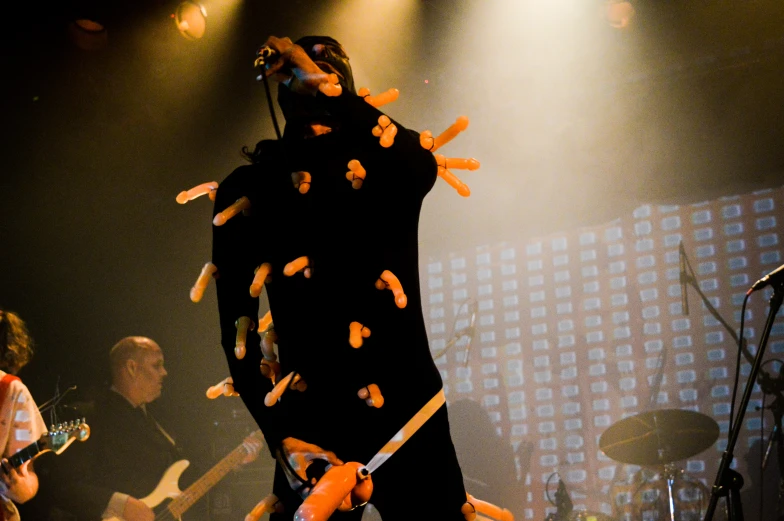 an image of a person with guitars in the air