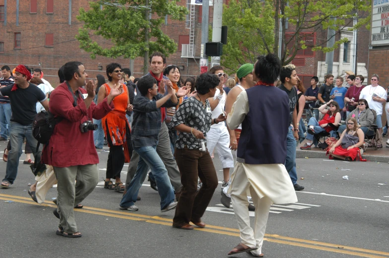 a street scene with people dancing in the middle of the street
