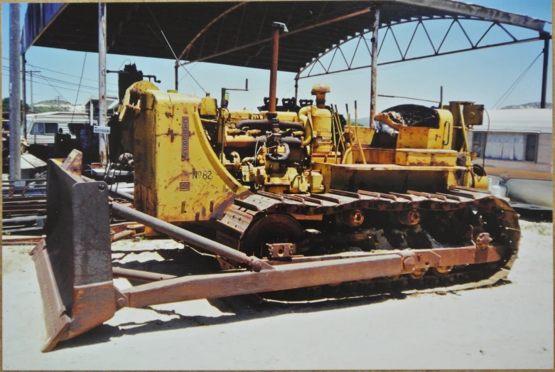 a large machine parked under a covered platform