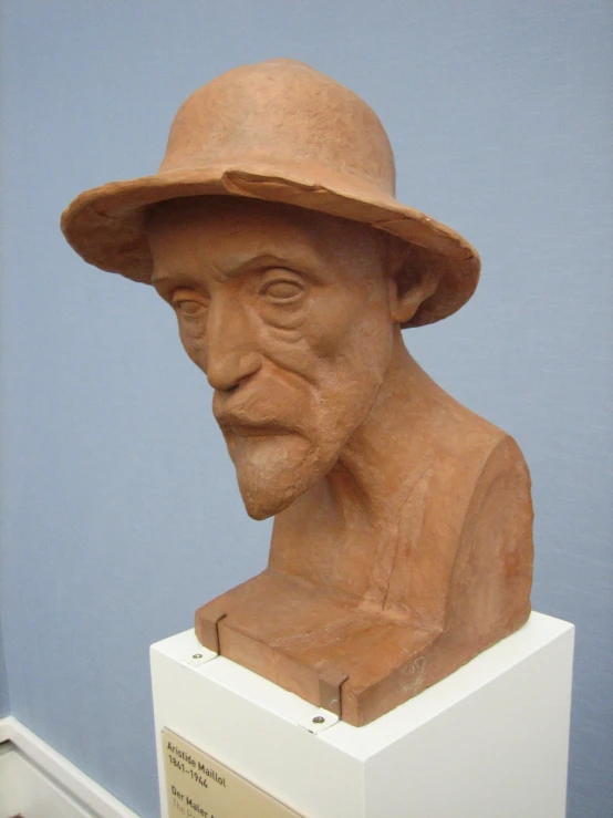 a statue of a man wearing a hat