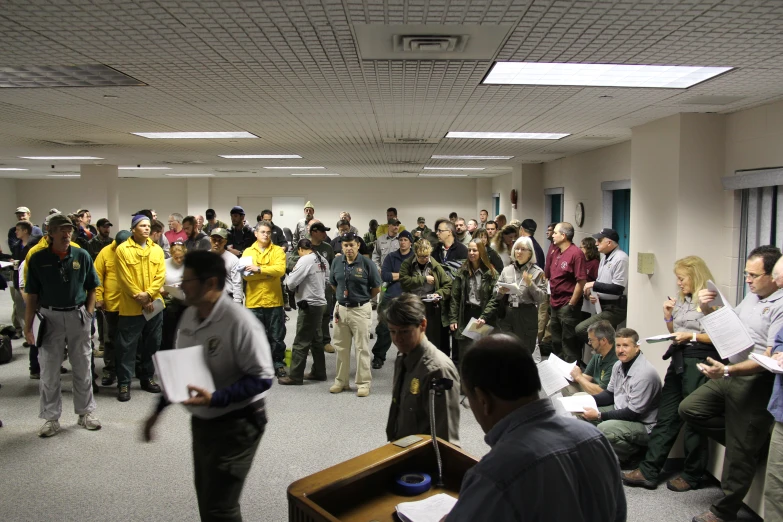 an audience is gathered in an office for a presentation