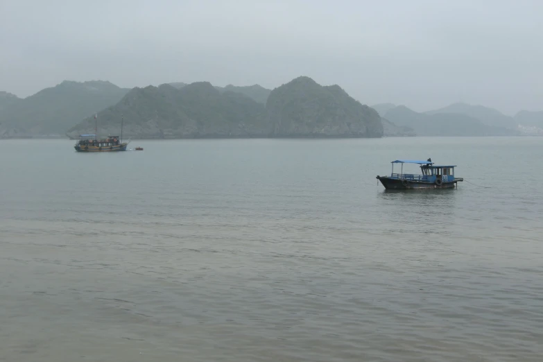 a boat in the water with mountains in the background