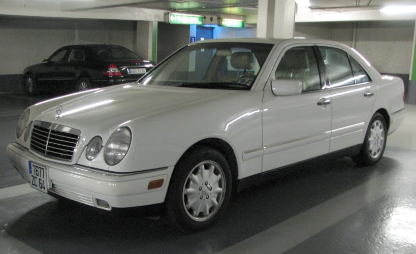 a white mercedes benz benz parked in a garage