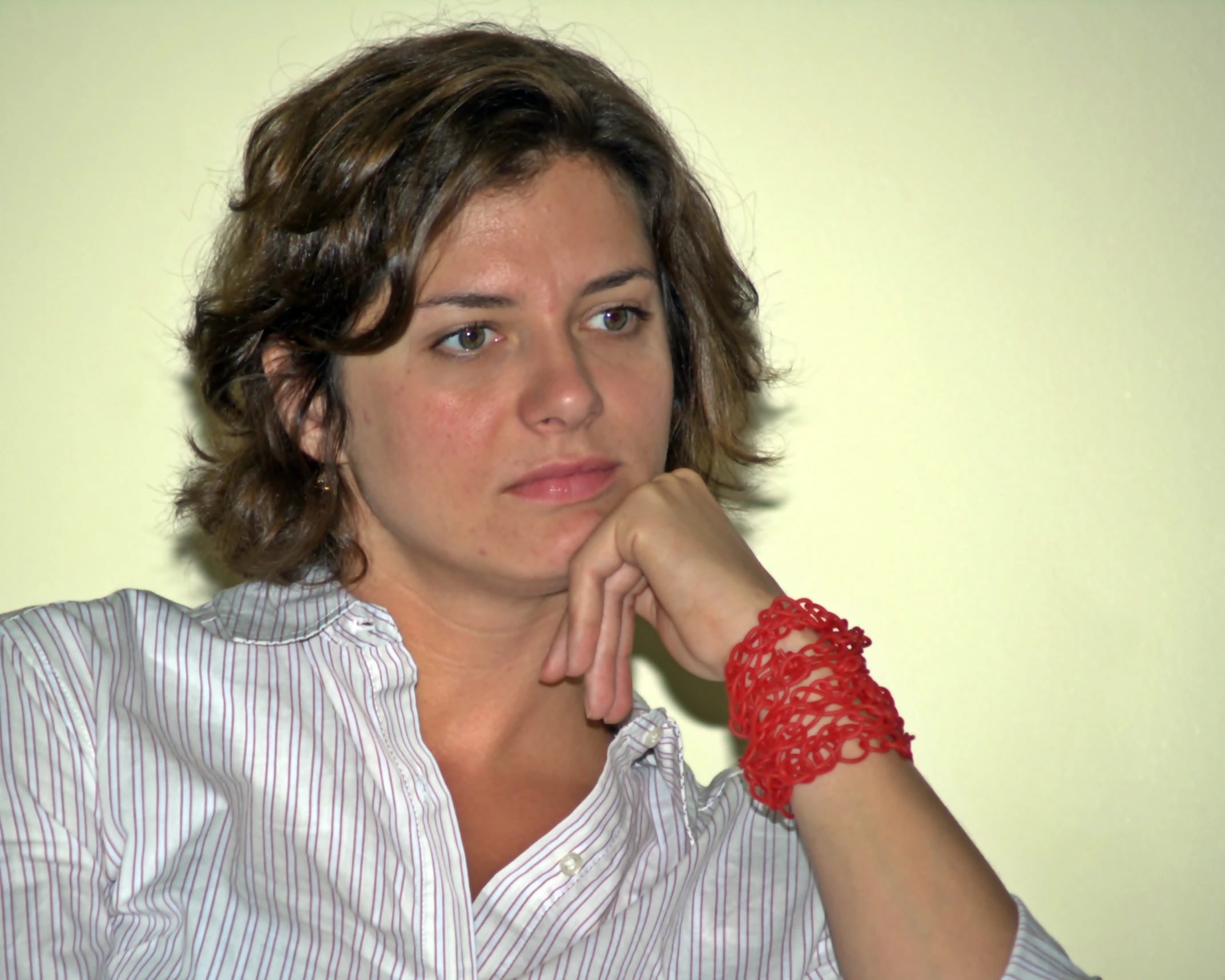woman in a white shirt with a red celet
