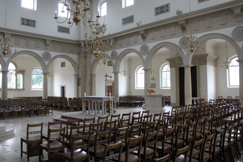 an empty church with pews and many chairs