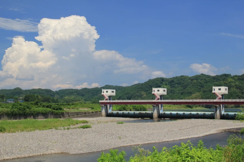 two white boxes are mounted to the side of a bridge