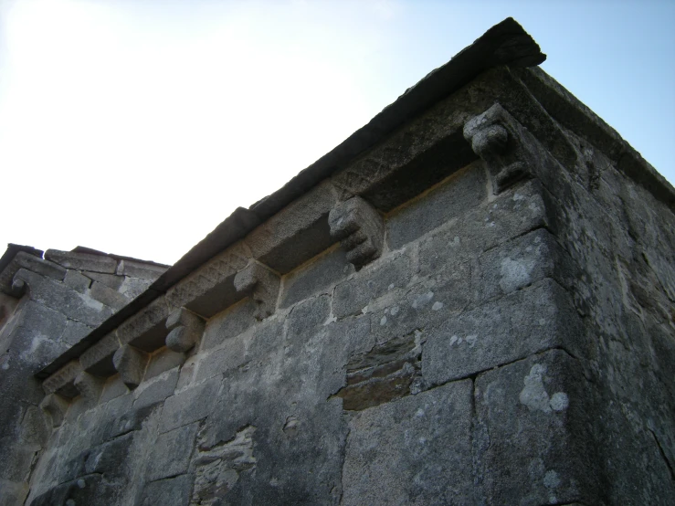 an old stone building with a clock on top