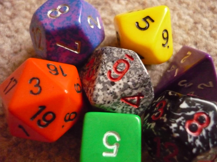 some different colored dice laying on top of each other