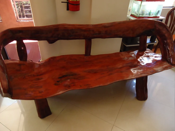 a bench made out of old logs in a living room