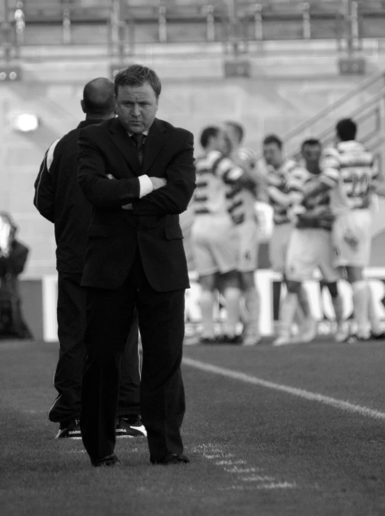 two men stand side by side in the middle of an arena