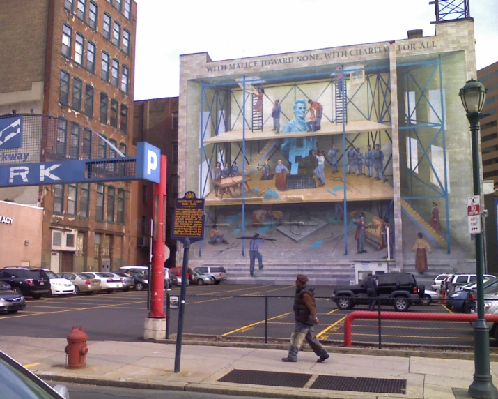 a large building with some people walking down the sidewalk