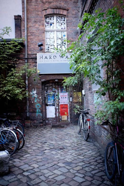 a brick building is shown with parked bikes in front