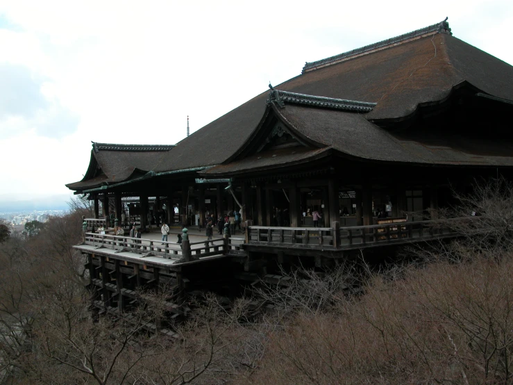 an old asian building with some small people on it