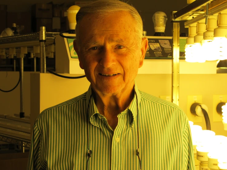 a man wearing a green and white shirt in front of lights